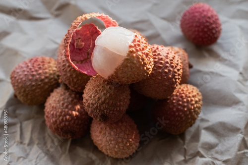 Exotic fruits are piled on top of a peeled fruit. Photographed from the side. Healthy food. Ingredients. For vegetarians.