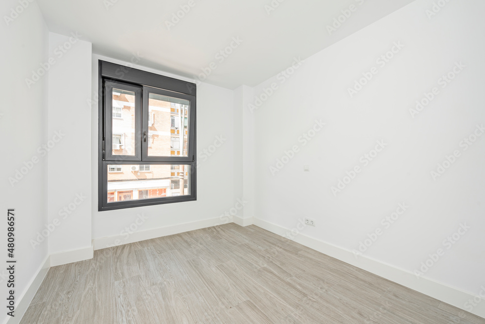 Empty room with black aluminum window with two unequal leaves and ceramic tile floors