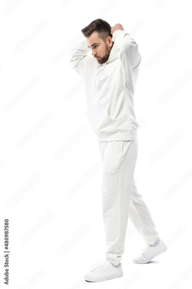 Handsome man wearing blank white hoodie and pants on white background Handsome man wearing blank white hoodie and pants on white background