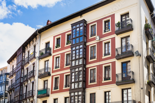 Facade of old buildings in Bilbao old town street. Residential houses in the city. Real estate business, classic architecture style concepts