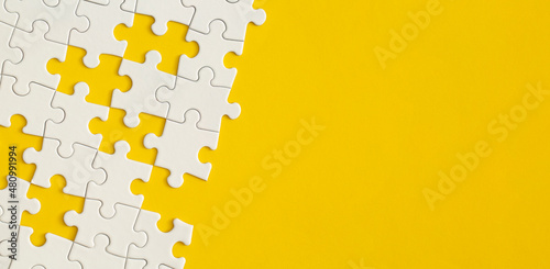 White details of puzzle on yellow background.