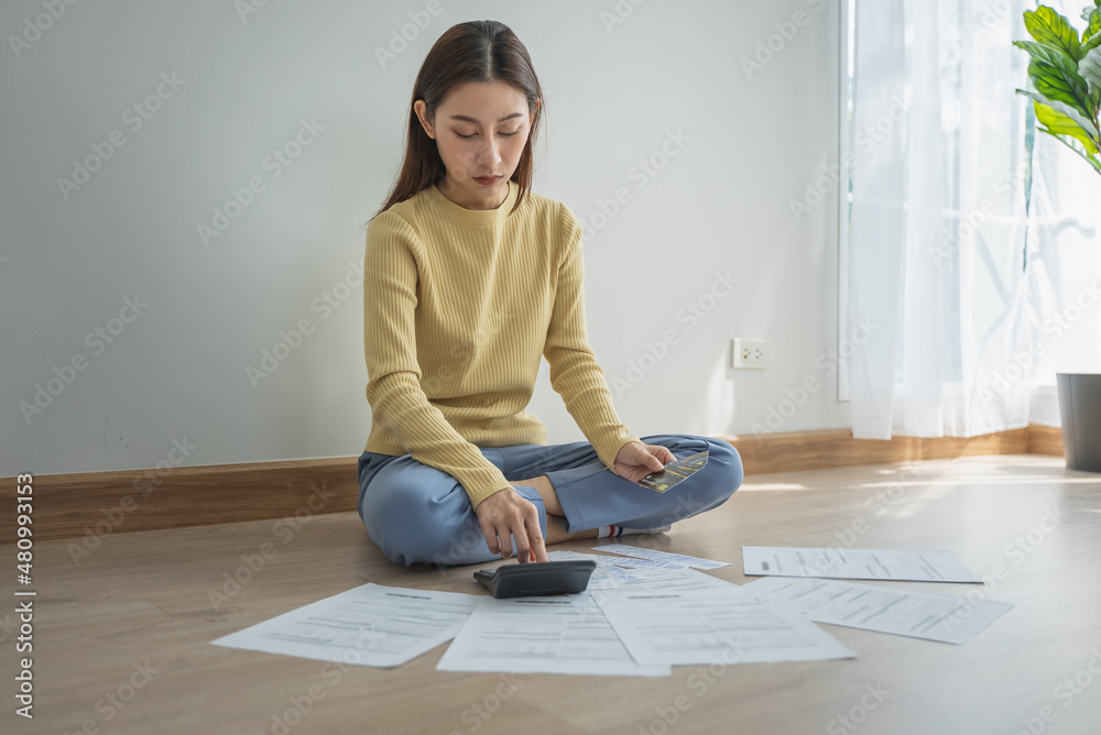 stressed young asian woman trying to find money to pay credit card debt. stressed young asian woman trying to find money to pay credit card debt.