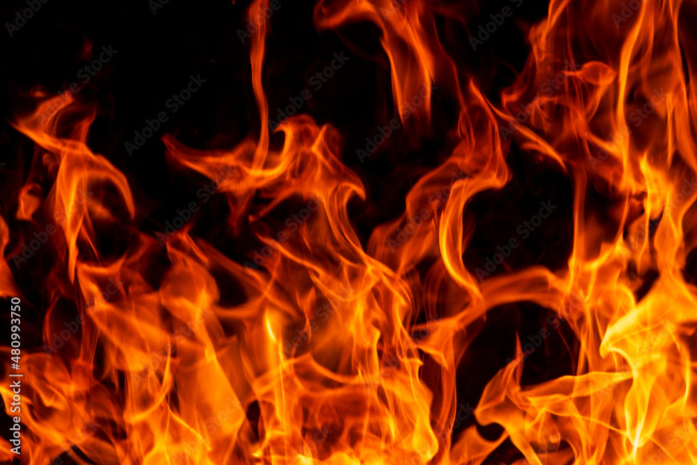 Abstract flame, fire flame texture, background. Blurred moving tongues of fire on a dark background. Abstract flame, fire flame texture, background. Blurred moving tongues of fire on a dark background.