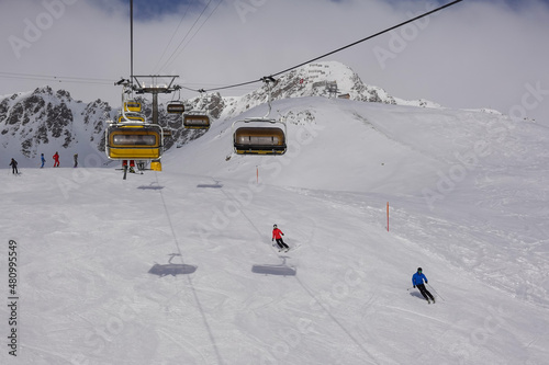 Obraz na płótnie Skiers and chair lift in the Saint Moritz ski resort in the alps in Canton Graubunden in Switzerland w salonie