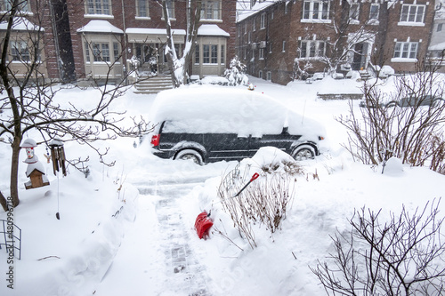 As a blizzard sweeps into a residential neighbourhood the streets fill with snow and residents start to shovel out their cars and sidewalks. Shot in Toronto’s Beaches neighbourhood in January.