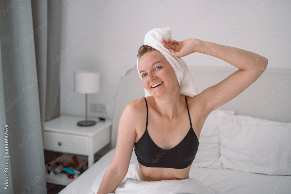 Lovely blonde posing in a bedroom after waking up with sunrise morning. Sweet dreams, good morning, new day, weekend, holidays concept Lovely blonde posing in a bedroom after waking up with sunrise morning. Sweet dreams, good morning, new day, weekend, holidays concept