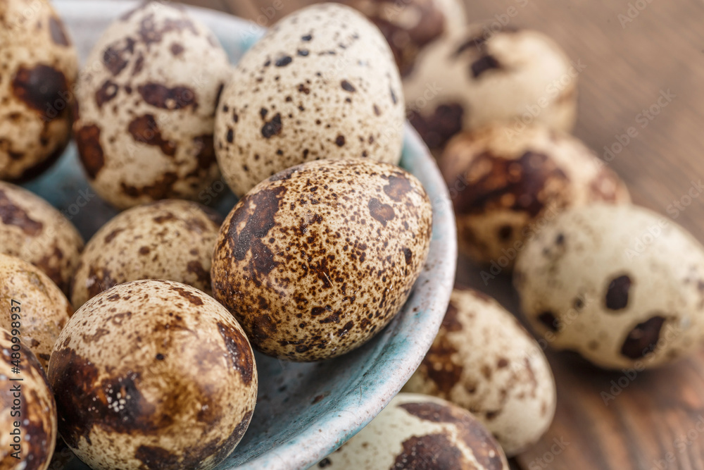 Quail eggs on the wooden plate. Quail eggs can be consumed by frying or boiling. In Indonesia quail eggs called telur puyuh. Quail eggs on the wooden plate. Quail eggs can be consumed by frying or boiling. In Indonesia quail eggs called telur puyuh.