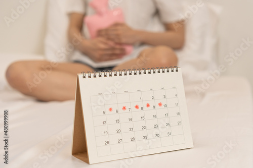 Menstruation, period cycle of monthly, hurt asian young woman, female hand in stomachache, suffer from premenstrual, belly or abdomen pain, using hot water bottle. Health problem Inflammation in body.