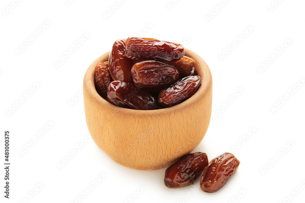 Wooden bowl of dried dates isolated on white background. Wooden bowl of dried dates isolated on white background.