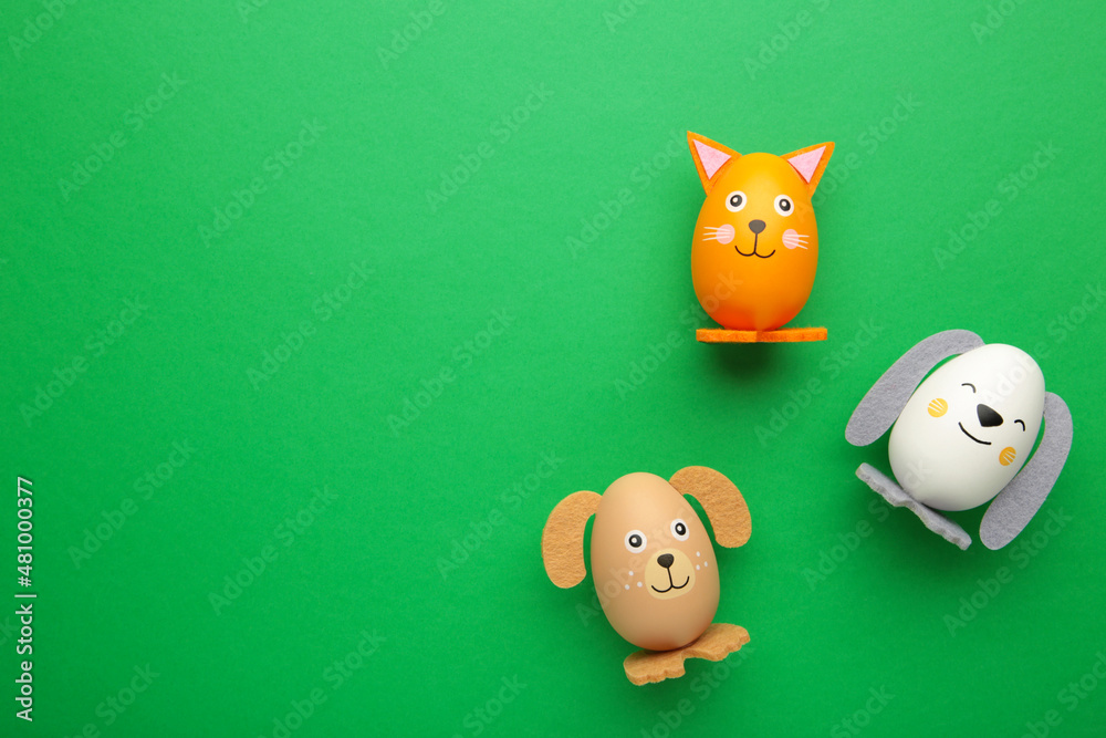 Easter holiday concept with cute handmade eggs, dogs and cat on green background. Easter holiday concept with cute handmade eggs, dogs and cat on green background.