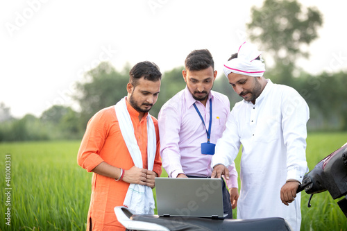Obraz na plátne Sales man in Agri Field showing farmers the concept in laptop