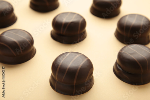 Chocolate sweets on a beige background. Biscuit