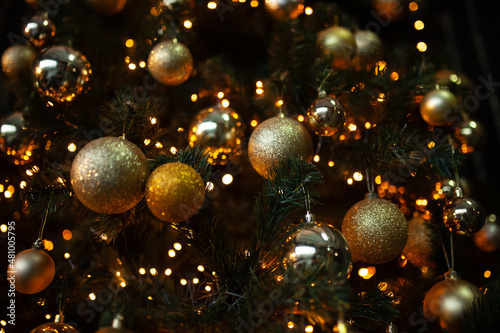 Christmas golden balls and a luminous garland on the Christmas tree 