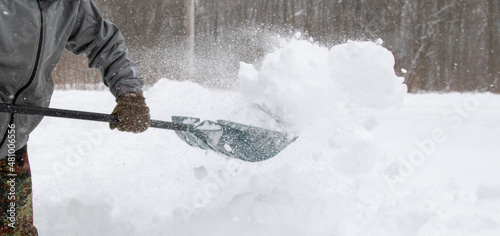 throwing snow with a shovel into snow bank photo