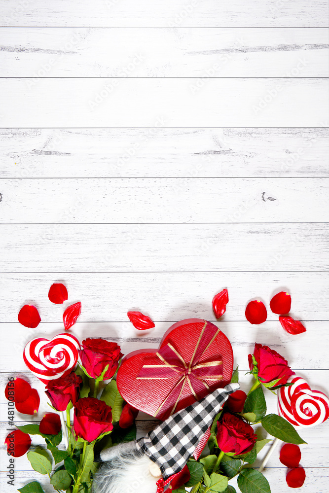Φωτογραφία Valentine's Day farmhouse theme background styled with red roses, heart shaped gift, and buffalo plaid gnome against a white wood background