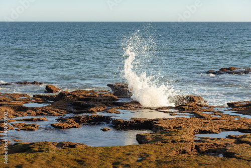 Waves crash over the rocks at Cadiz Bay at sunset, Andalusia, Spain