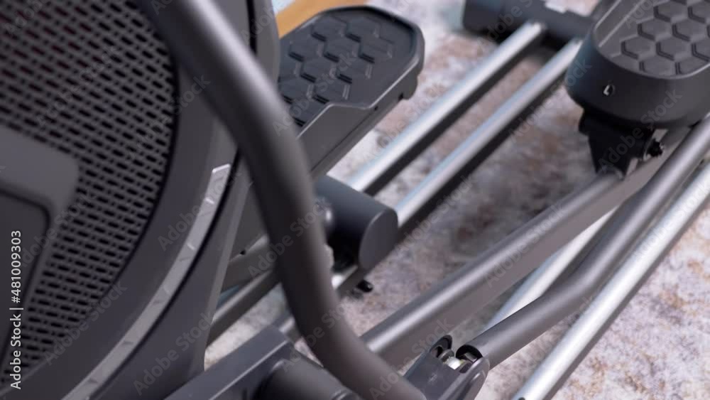 Spinning Elliptical Trainer Pedals. Testing, demonstration of the rotation of the mechanism of the sliders of the left and right pedals. Movement on adjustable foot pedals. Cardio cross-trainer. 4K. Spinning Elliptical Trainer Pedals. Testing, demonstration of the rotation of the mechanism of the sliders of the left and right pedals. Movement on adjustable foot pedals. Cardio cross-trainer. 4K.