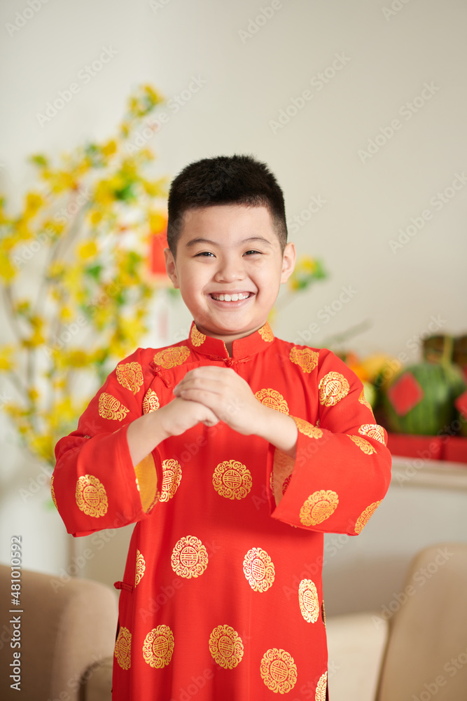 Happy boy in traditional ao dai dress making greeting gesture Stock Photo Adobe Stock