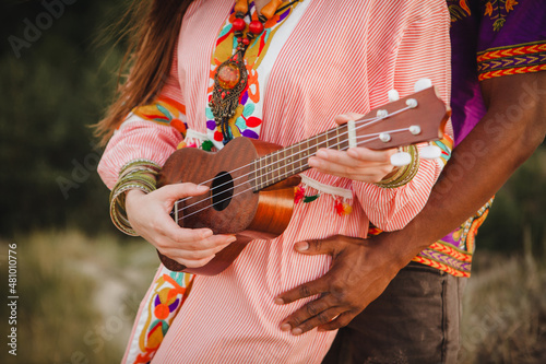 the ukulele in hands close up in the day