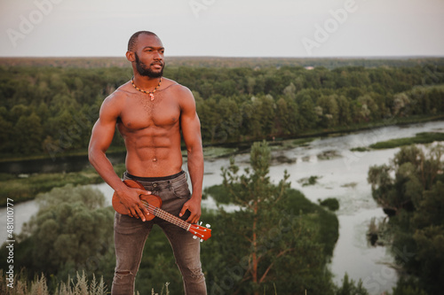young african american sports man with ukulele