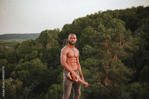 young african american sports man with ukulele