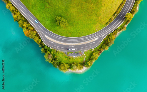 The road near turquoise lake. Aerial landscape. The road by the lake in Switz...