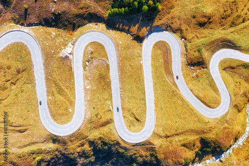 A road with turns through a mountain pass. Aerial landscape. An aerial summer...