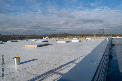 Construction of a flat roof with EPDM (ethylene propylene diene monomer) membrane on a large warehouse photo