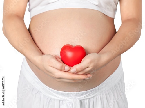 Wallpaper Mural Pregnant mother showing her belly and holding a mini heart Torontodigital.ca