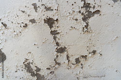 Old wall with cracked damaged white paint close up © vajna