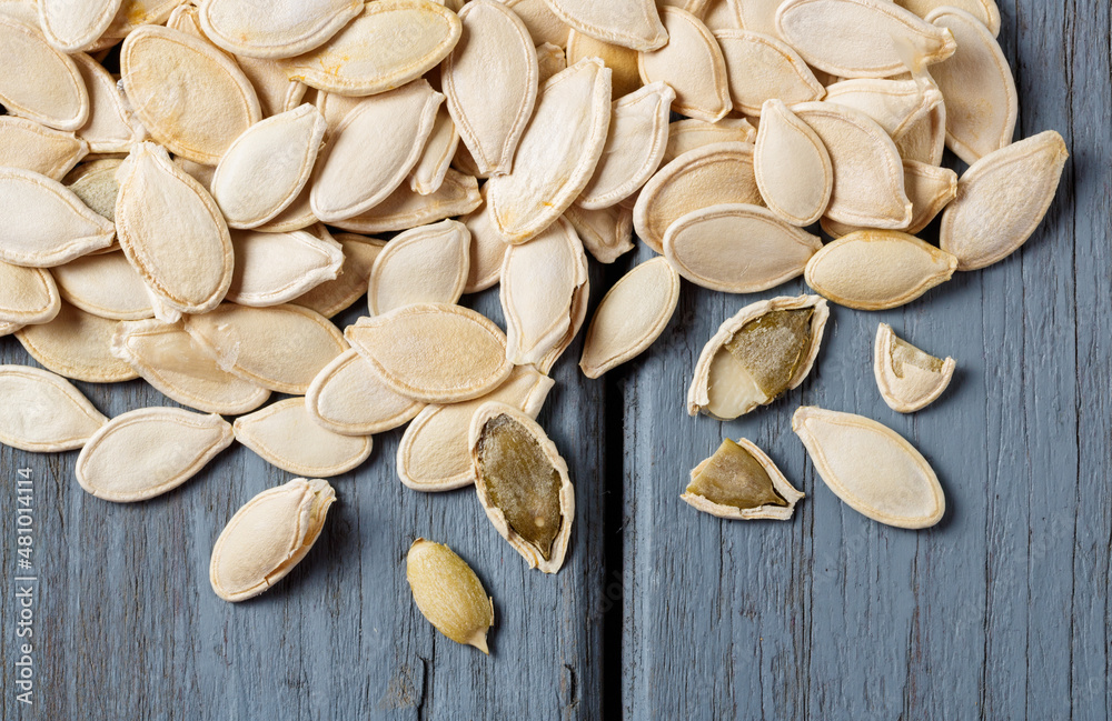 Pumpkin seeds on a gray rustic table. View from above.