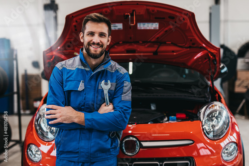 A professional mechanic working in a car service.