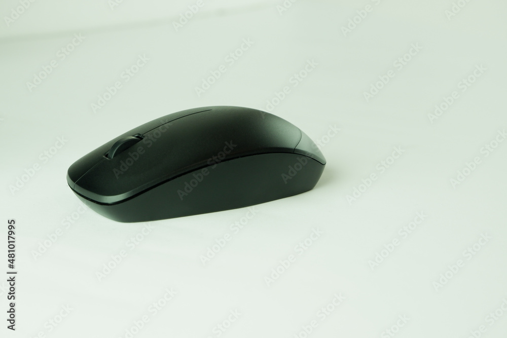 Black computer mouse on a light background. Close-up photo Mouse computer equipment Black computer mouse on a light background. Close-up photo Mouse computer equipment