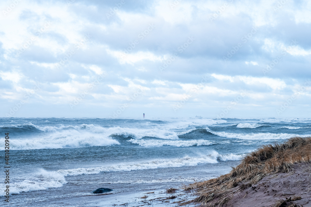 Stormy weather by the sea in Riga, Latvia. Huge waves crashing down the coast of Latvia.