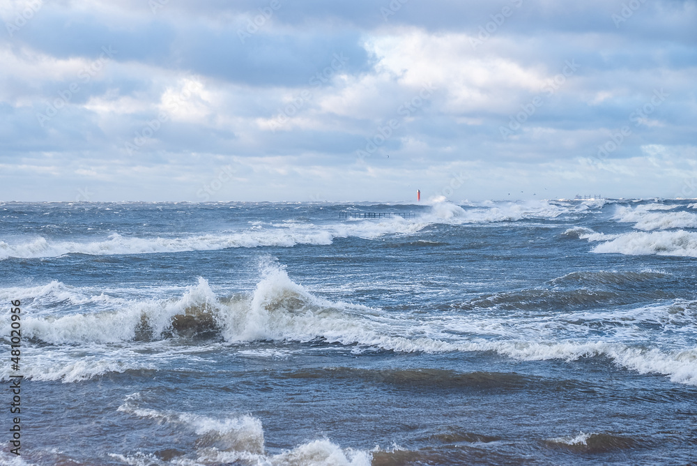 Fototapeta premium Stormy weather by the sea in Riga, Latvia. Huge waves crashing down the coast of Latvia.