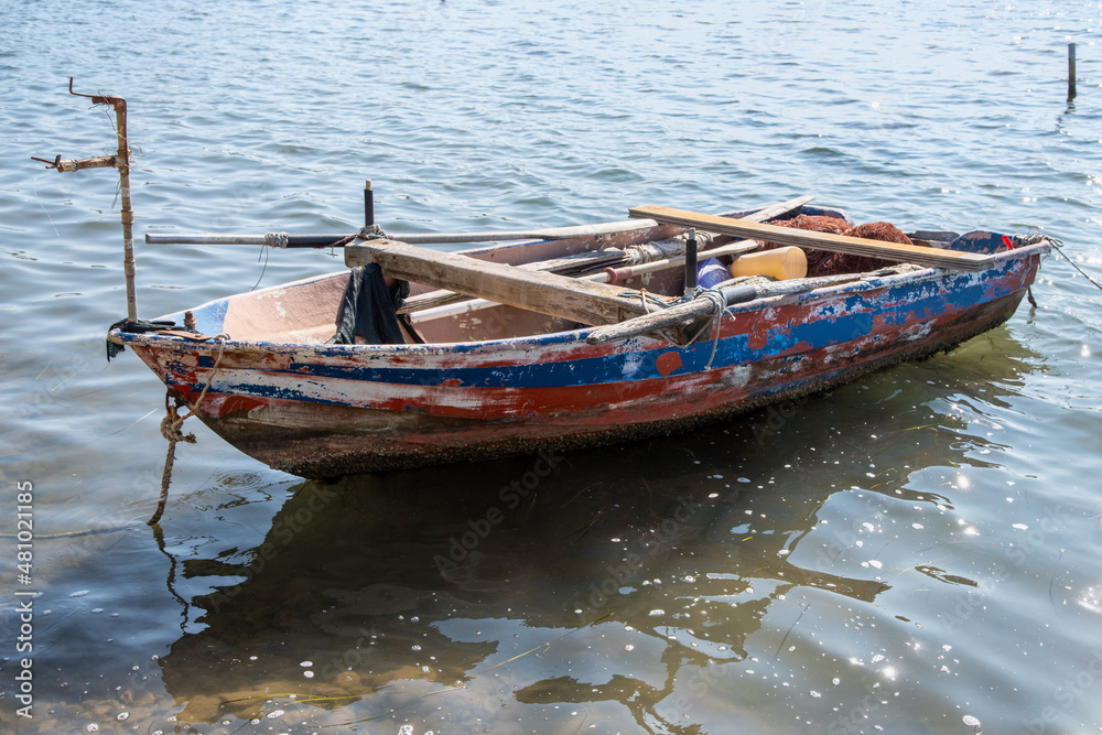Very old and weathered, wooden fisher boat on the water Very old and weathered, wooden fisher boat on the water