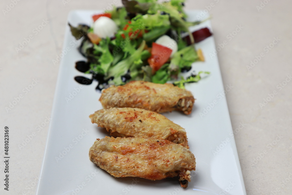 chicken wings with salad