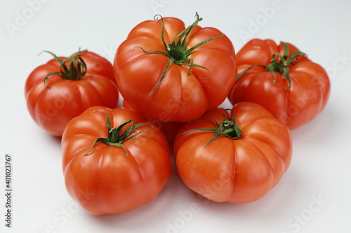 Organic tomatoes on a white background. Close-up