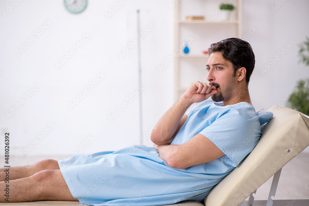 Young male patient waiting for doctor at the hospital Young male patient waiting for doctor at the hospital
