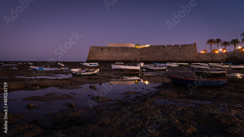 Beached boats at low tide in La Caleta beach at sunrise, Cadiz, Andalusia, Spain © JMDuran Photography