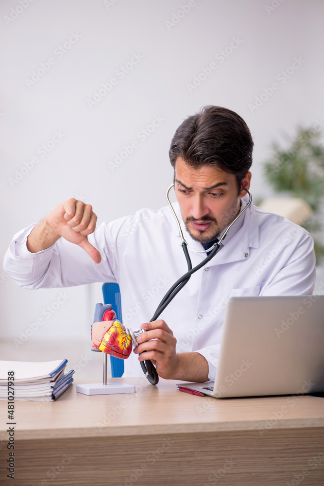 Young male doctor cardiologist working in the clinic Young male doctor cardiologist working in the clinic