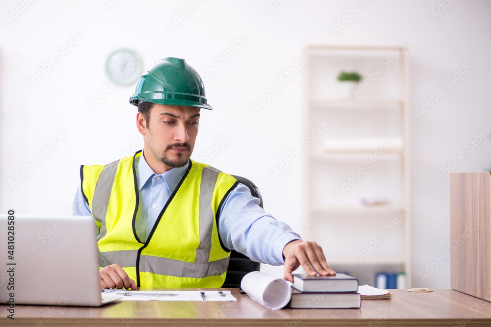 Young male architect working in the office