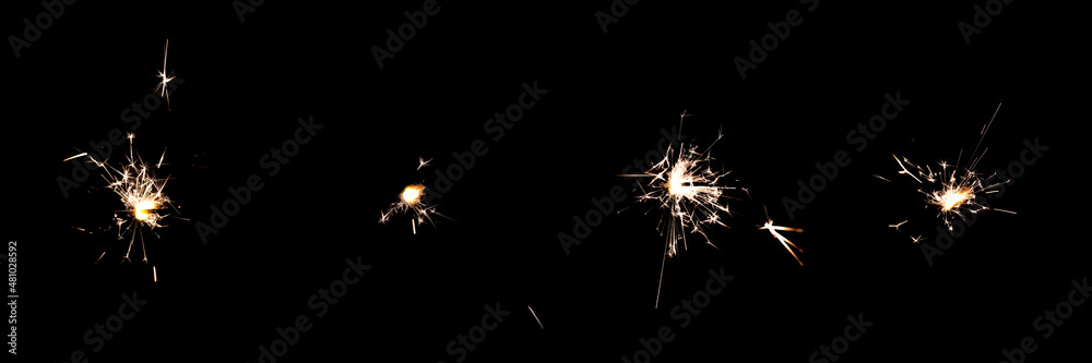 4-pack of birthday Sparklers Isolated on black background. Sparklers sparks from burning Pyrotechnics on Black overlay. Orange birthday fireworks Glitter lights for party and event designs.