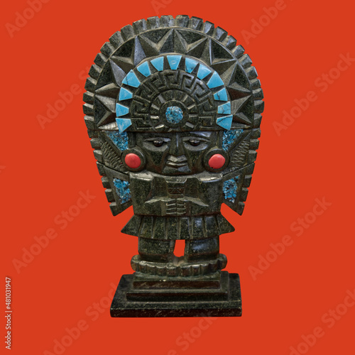 a decorative mayan statuette isolated on a red background photo