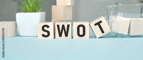 Abbreviation SWOT on wooden cubes. Business concept.
