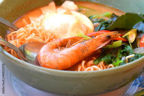 Thai Spicy creamy Tom Yum instant noodles with king prawns, egg and vegetables, seasoning with red chili, lemongrass