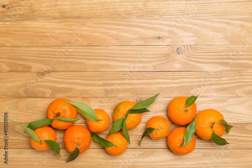 Flat lay with fresh mandarines on wooden background