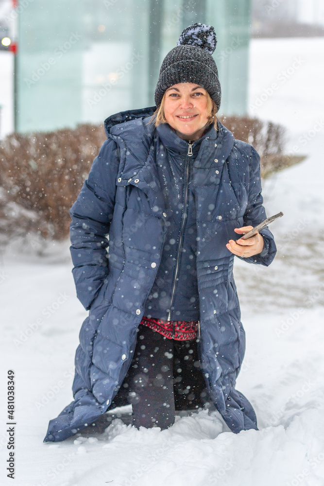 Fototapeta premium Woman Walking in Deep Snow