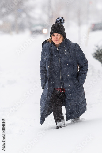 Woman Walking During a Snowstorm