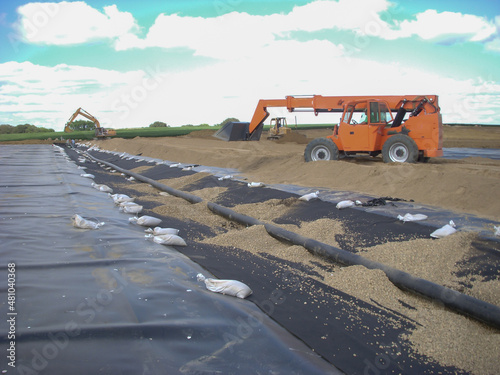 Installation of a leachate collection system under a new landfill with a liner and perforated rock. photo